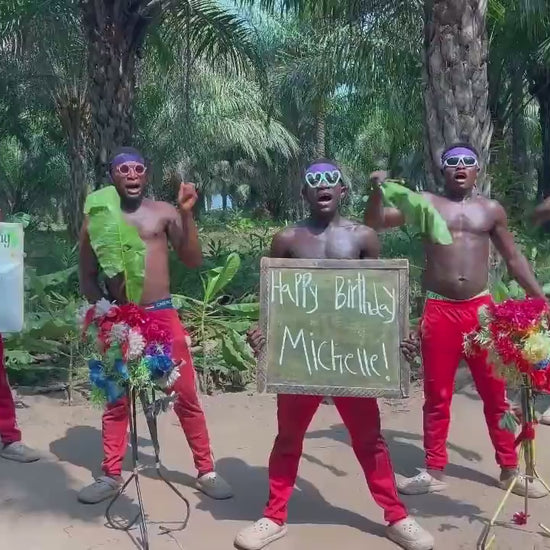 African performers in red traditional outfits recording a personalised video greeting